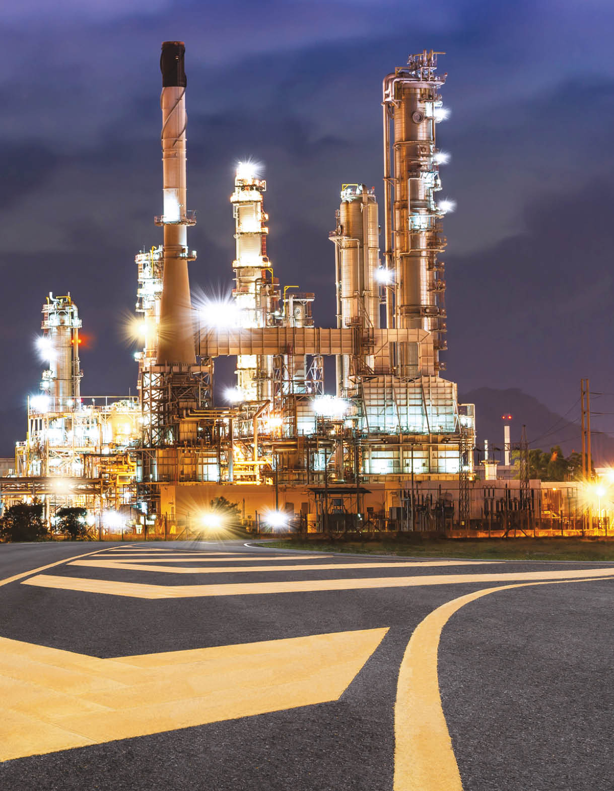 Road to the oil refiner on blue sky in sunset time